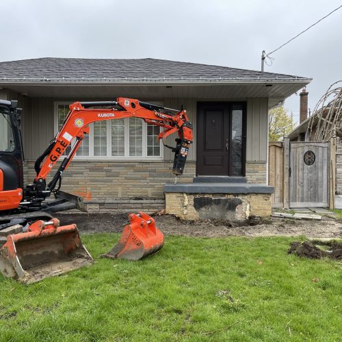 Excavator Demolishing old porch